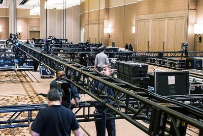 Event production crew loading in AV equipment and staging for conference